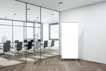 Spacious conference interior with blank vertical poster.