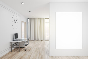 Office interior with clock and blank poster on wall.