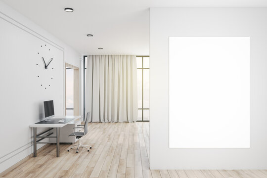 Office interior with clock and blank poster on wall.