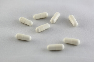 closeup of white pills on white background