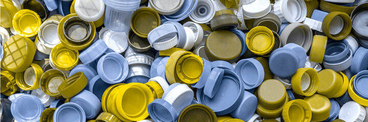 Single use plastic bottle caps are collection for recycling. Recycling plastic, ecology, waste management, environmental issues concept. Background. Wide banner