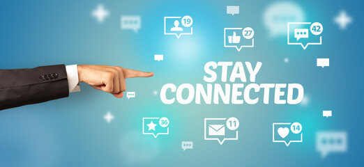 Close-Up of cropped hand pointing at STAY CONNECTED inscription, social networking concept