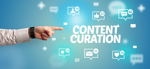 Close-Up of cropped hand pointing at CONTENT CURATION inscription, social networking concept