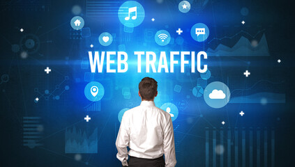 Rear view of a businessman with WEB TRAFFIC inscription, modern technology concept