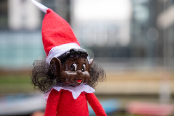 A biracial naughty elf doll