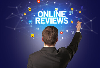 Rear view of a businessman with ONLINE REVIEWS inscription, social networking concept