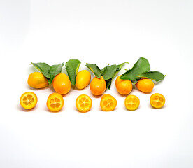 organic kumquat is the smallest fruit of the citrus family, vitamin C. Along with green leaves. With white background