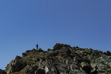 Tourist on the top of rock in Tirol Alps silhouette.