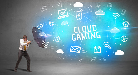 Businessman defending with umbrella from CLOUD GAMING inscription, modern technology concept
