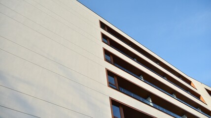 Obraz premium Facade of new apartment building. Glass balcony and clean look of modern architecture building with blue sky background.