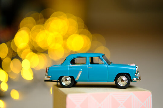 Toy car model Moskvich 402 with bokeh on the background.