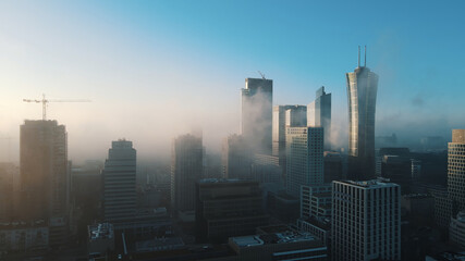 Warsaw business center, skyscrapers, buildings and cityscape in the morning fog, aerial. High...