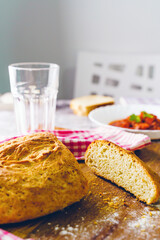 Fresh homemade baked bread on the table at home ready to eat copy space