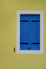blue window on yellow wall