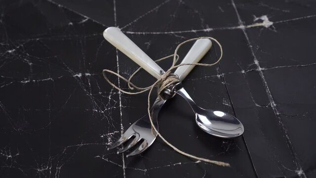 Jute tied spoon and fork on crumpled wrinkled shabby old paper. Diet motivation concept
