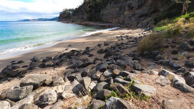 pristine wild landscape at Boronia Beach in Tasmania, Australia with lush vegetation and rocks on the shore