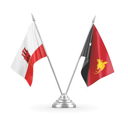 Papua New Guinea and Gibraltar table flags isolated on white 3D rendering