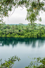 Fototapeta na wymiar The view of Ubin Quarry lake and rainforest from Puaka’s Hill. It is located in the western part of pulau ubin island Singapore. The background is Malaysia. 
