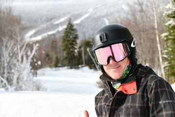 Fototapeta na wymiar Happy Snowboarder on the Stowe mountain VT slopes