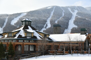 View to the Stowe Mountain Ski Resort lodge and peak Mansfield slopes from  Spruce peak in mid...