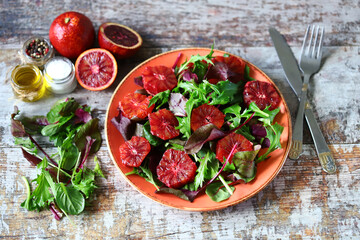 Soft focus. Fresh juicy salad with arugula and red orange. Vegan salad. Slimming food.