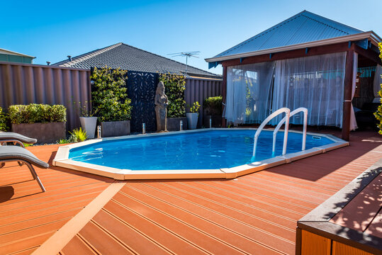 Above Ground Pool Sunken Below Ground And Surrounded By Decking.