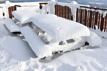Fresh snow on the cafe table at observation deck at Stowe Ski resort, VT
