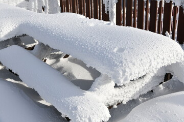 Fresh snow on the cafe table observation deck at peak Mansfield summit - Stowe Ski resort, VT