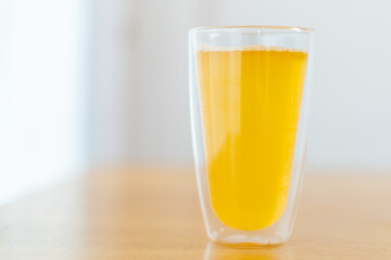 Tablet of calcium effervescent melting in a drinking water close up with copyspace.