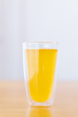 Tablet of calcium effervescent melting in a drinking water close up with copyspace.