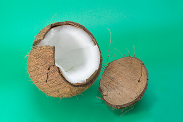 Delicious coconut, isolated on green background, flat layout, top view