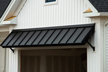 metal roof against the wall of building