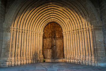 A closeup of the Romanesque semicircular arches at the portal of the Convent of Sant Salvador...