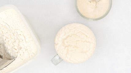 Homemade starter yeast growing. Step by step bread dough recipe, close up view from above
