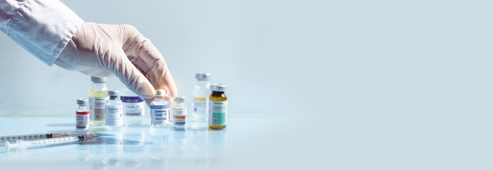 Covid-19 Vaccination Research and Development concept. Hand of a researcher select a potential...