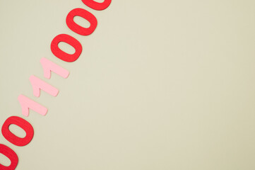 A top view of red and pink binary codes on a white surface
