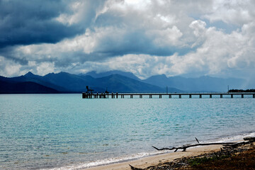 Storm clouds over Hinchinbrook Island and Cardwell jetty located on the Cassowary Coast in Far North Queensland Australia