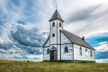 Fototapeta na wymiar Clouds surround Peace Lutheran Church in Stonehenge, Saskatchewan