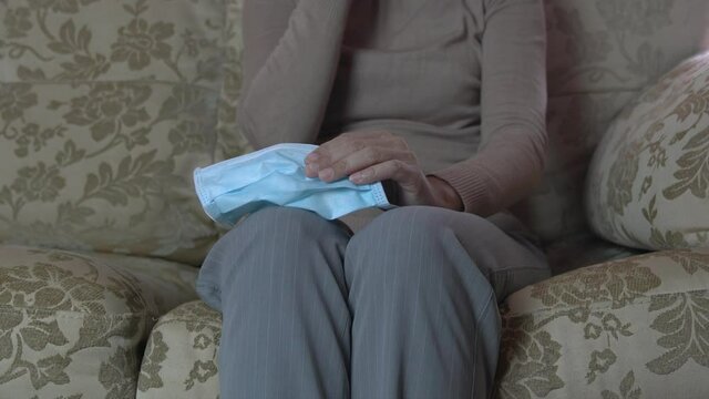 Closeup View Of Woman’s Hands With Tissue Paper From Crying And Face Mask. Anxiety Or Attending Counseling Therapy Session For Mental Health Concept.