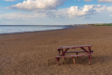 Fototapeta na wymiar A picnic bench and table on Heacham South Beach, Norfolk, England, UK