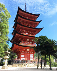 Orange vermilion Pagoda building sunny day Miyajima island Japan