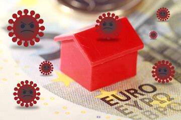 A closeup of a house figurine on a Euro banknote surrounded by angry viruses - virus impact on housing