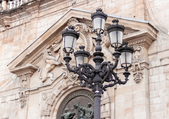 A vertical shot of beautiful metallic street lamps against a building