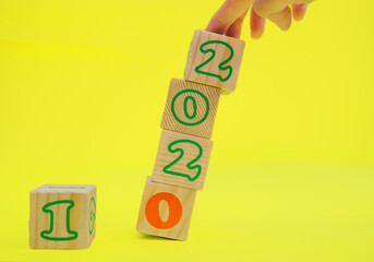 Wooden cubes with the numbers 2021 on a yellow background. The concept of a New year.New date.