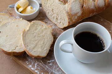 Fototapeta na wymiar Breakfast table with Italian bread, butter and black coffee