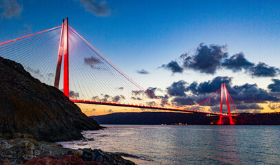 The miraculous view of Yavuz Sultan Selim Bridge, taken at sunset, illuminating the city with its lights.