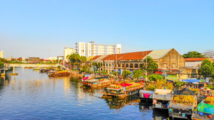 Fototapeta na wymiar Aerial view of Ben Binh Dong (Binh Dong harbour) in lunar new year ( Tet Festical in Vietnam) with flower boats along side the river.
