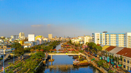 Obraz premium Aerial view of Ben Binh Dong (Binh Dong harbour) in lunar new year ( Tet Festical in Vietnam) with flower boats along side the river.