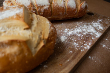 Italian breads on rustic floured wooden board