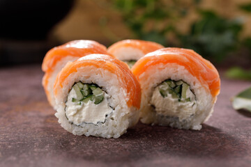 Philadelphia roll sushi on textured background still life. Restaurant concept. Close-up.
